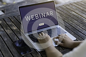 Person using a laptop computer for online training webinars. E-learning browsing connection and cloud online technology webcast