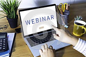 Person using a laptop computer for online training webinars. E-learning browsing connection and cloud online technology webcast