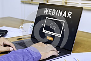 Person using a laptop computer for online training webinars. E-learning browsing connection and cloud online technology webcast