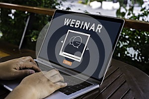 Person using a laptop computer for online training webinars. E-learning browsing connection and cloud online technology webcast