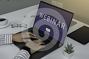 Person using a laptop computer for online training webinars. E-learning browsing connection and cloud online technology webcast