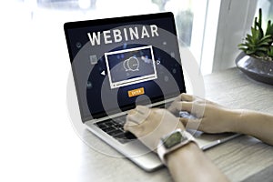 Person using a laptop computer for online training webinars. E-learning browsing connection and cloud online technology webcast