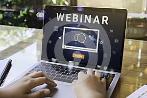 Person using a laptop computer for online training webinars photo