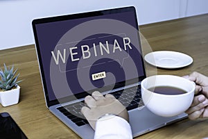 Person using a laptop computer for online training webinar. E-learning browsing connection and cloud online technology webcast