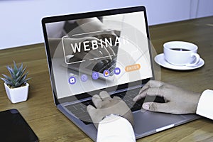 Person using a laptop computer for online training webinars. E-learning browsing connection and cloud online technology webcast