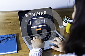 Person using a laptop computer for online training webinars.