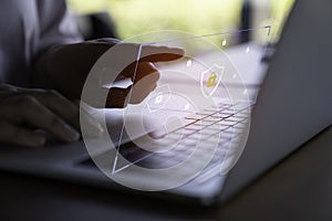 Person using a laptop computer with technology cybersecurity and privacy concept. protection and safe data for global network