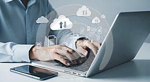 Person using laptop with digital cloud data transfer icons and documents technology