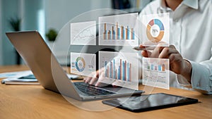 Person using laptop interacts with holographic data charts graphs business analytics visualization