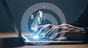 Person using laptop with shield icon and security data visualization computer protection