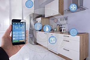 Person Using Smart Home Application On Smartphone