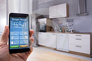 Person Using Smart Home System On Mobilephone
