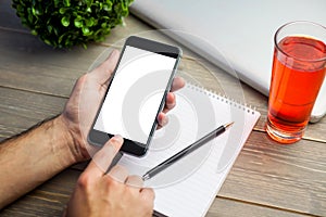 Person using smart phone at table