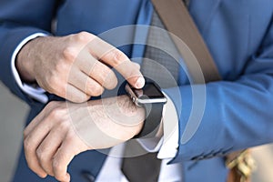 Person using smart watch and a smartphone walking on the park