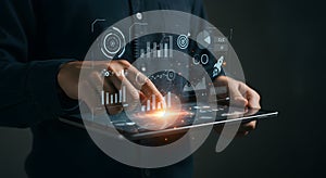 Person Analyzing Digital Data on Touchscreen Device with Orange Light