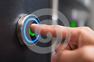 User activating a biometric security system with a fingerprint scanner in a modern building