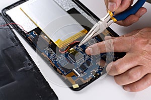 Person using Tools to Repair Electronic Device