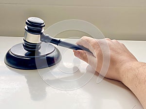 A person using Wooden Gavel with Round Block for Judge Lawyer