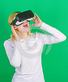 A person in virtual glasses flies in room space. Person with virtual reality helmet isolated on green background. Woman