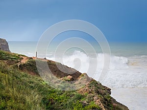 a person walking along the ocean shore at cape de nir