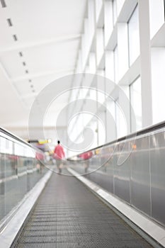 Person walking away on airport walkway