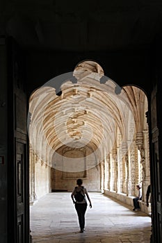 Person walking in Jeronimos Monastery cloister