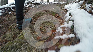 Person walking on a mountain trail in winter