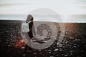 A person walking over an Icelandic beach