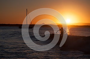 Person Walking In Sea Wave During Sunset