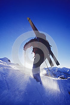 Person Walking In Snow With Skis
