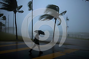 person walking with an umbrella against strong precyclone winds