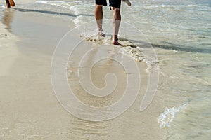 Person walks along a paradisiacal Caribbean beach