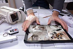 Person Watching Footage On Digital Tablet