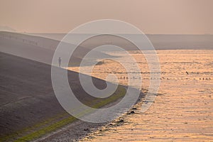 Person watching sunset from Sea in orange haze
