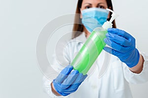 Person Wearing Medical Gown Gloves For Performing Laboratory Experiment. Holding Test Tube Of Blood For Health Condition