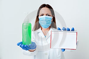 Person Wearing Medical Gown Gloves For Performing Laboratory Experiment. Holding Test Tube Of Blood For Health Condition