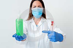 Person Wearing Medical Gown Gloves For Performing Laboratory Experiment. Holding Test Tube Of Blood For Health Condition