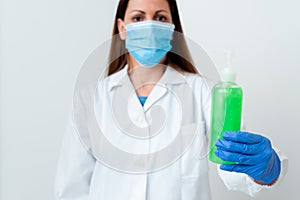 Person Wearing Medical Gown Gloves For Performing Laboratory Experiment. Holding Test Tube Of Blood For Health Condition