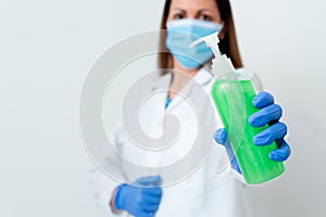 Person Wearing Medical Gown Gloves For Performing Laboratory Experiment. Holding Test Tube Of Blood For Health Condition