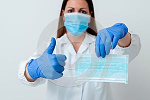 Person Wearing Medical Gown Gloves For Performing Laboratory Experiment. Holding Test Tube Of Blood For Health Condition