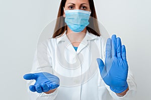 Person Wearing Medical Gown Gloves For Performing Laboratory Experiment. Holding Test Tube Of Blood For Health Condition