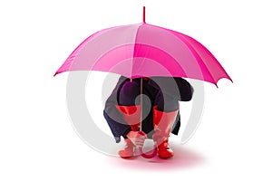 Person wearing red rubber shoes and rain umbrella isolated on white background