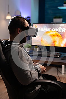 Person wearing vr glasses to play video games with controller