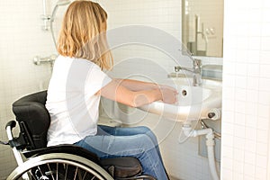 Person in a wheelchair washing hands