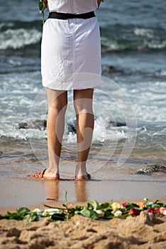 A person who is a fan of candomble on the beachfront paying homage to iemanja on Rio Vermelho beach in Salvador, Bahia