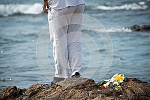 A person who is a fan of candomble on the beachfront paying homage to iemanja on Rio Vermelho beach in Salvador, Bahia