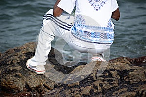 A person who is a fan of candomble on the beachfront paying homage to iemanja on Rio Vermelho beach in Salvador, Bahia