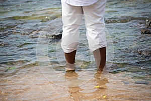 A person who is a fan of candomble on the beachfront paying homage to iemanja on Rio Vermelho beach in Salvador, Bahia