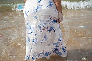 A person who is a fan of Candomble is seen entering the water on the beach to pay homage to Iemanja. City of Salvador, Bahia