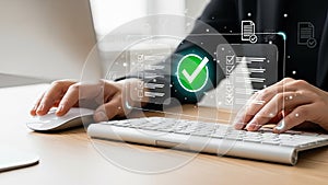 Person working on computer with digital verification and document management system